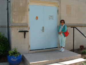Elaine Little, Assistant Director of the Kateri Center, with newly painted door.